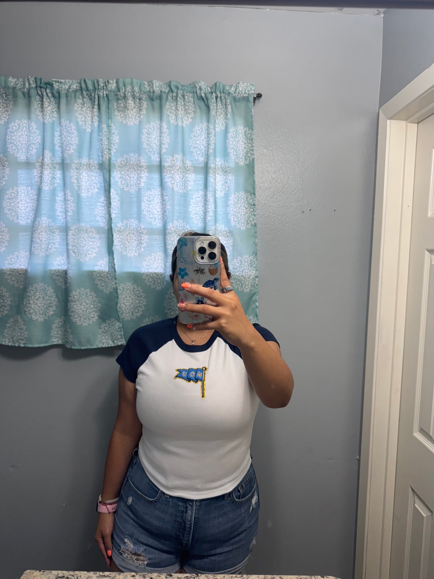HOU patch on a navy baby tee
