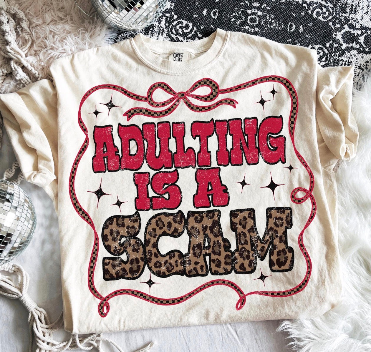 adulting is a scam beige tee
